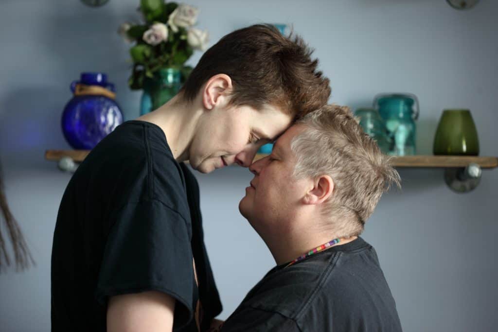 Queer Couple Kissing and Embracing - LGBT Healthcare Disparities
